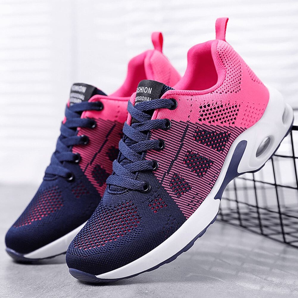 Pink and navy lace-up breathable running shoes with cushioned sole on display, featuring wear-resistant mesh for superior comfort.
